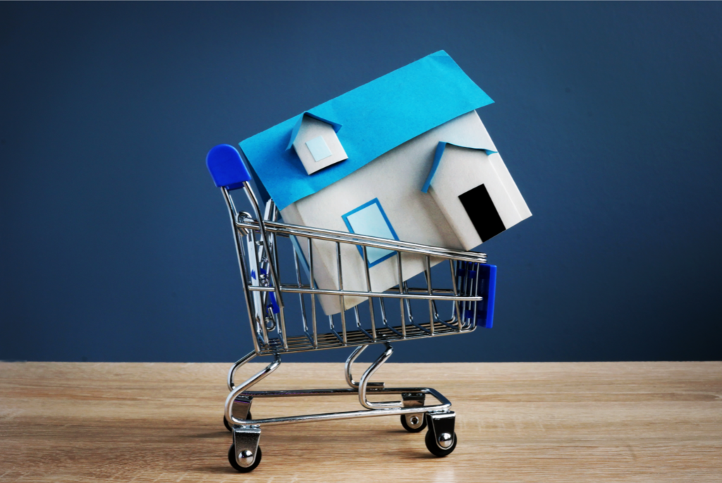 Model house in a shopping cart symbolizing the sale of real estate property in Ohio, representing a strategic approach to selling rental homes.