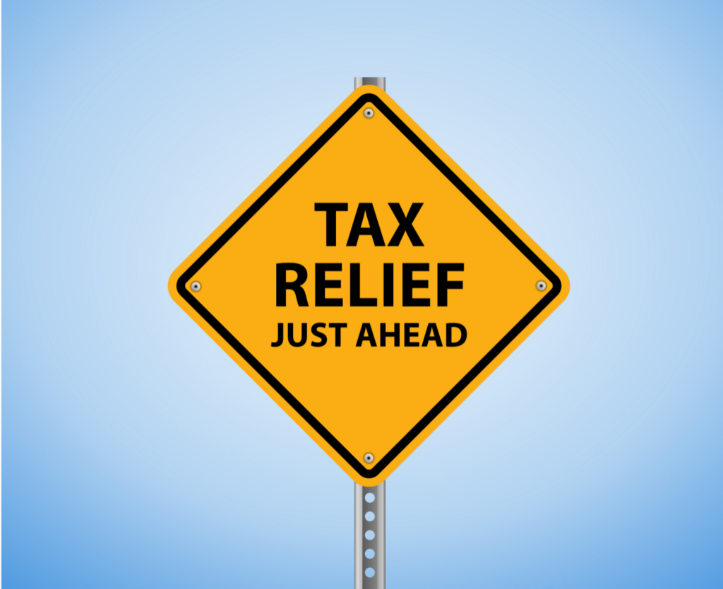 Yellow road sign reading 'TAX RELIEF JUST AHEAD' against a blue sky, symbolizing the hope for Ohio homeowners seeking information on property tax assistance and delinquency prevention.