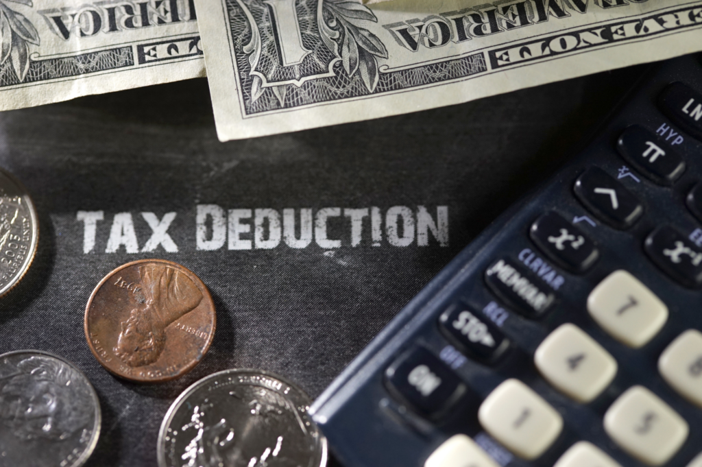 Calculator and money depicting tax deductions for home improvements.