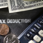 Calculator and money depicting tax deductions for home improvements.