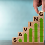 Hand placing the final block on a rising graph of savings, concept for increasing home sale profits in Columbus.