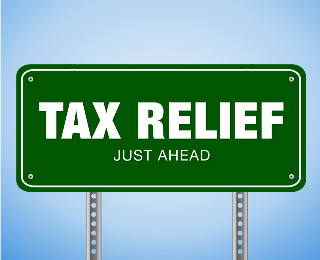 Green road sign stating 'TAX RELIEF JUST AHEAD' symbolizing upcoming tax deductions for Ohio homeowners.