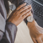 Professional woman checking the time on her watch, planning the best season to sell property in Ohio.