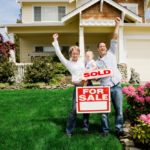 Happy family celebrating with a 'SOLD' sign in front of their Cincinnati home, depicting a successful and quick sale by following expert real estate advice.