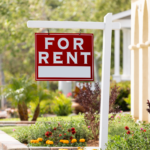 Inviting Cleveland home with 'For Rent' sign amidst vibrant garden, perfect for rental conversion.