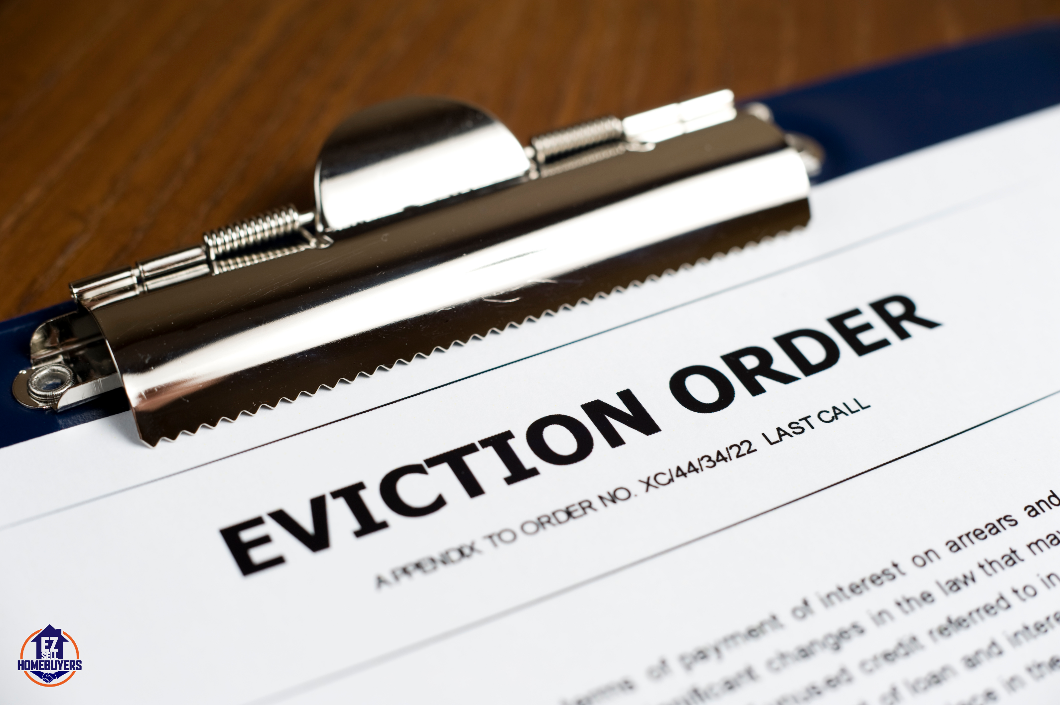 Close-up of an eviction order clipboard with a metal clip, highlighting the legal process of removing squatters in Cincinnati, Ohio.