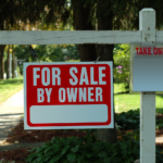 FSBO sign with flyers on a residential Cleveland street, inviting direct homebuyer inquiries