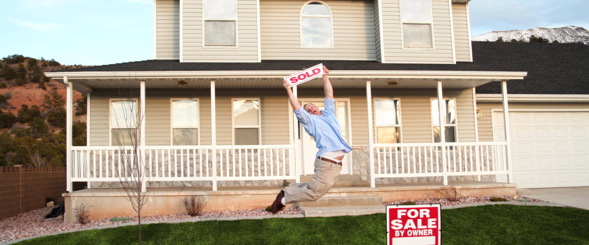Homeowner celebrating a successful FSBO sale with a 'SOLD' sign in front of a Toledo suburban house