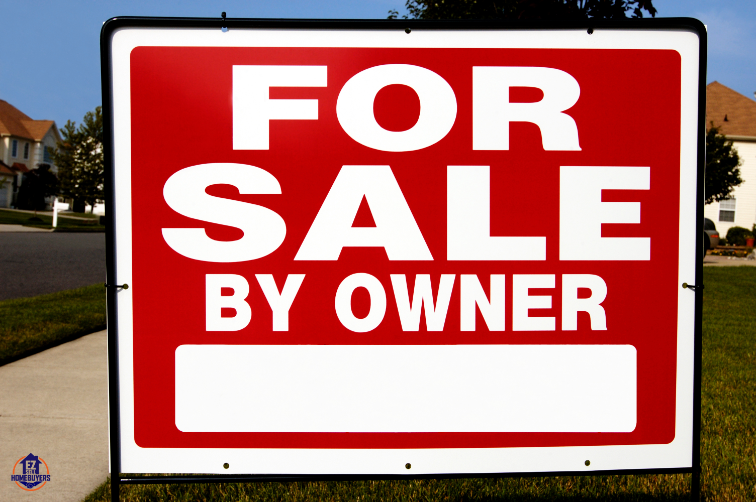 Bold red 'For Sale By Owner' sign on a suburban lawn in Akron, Ohio