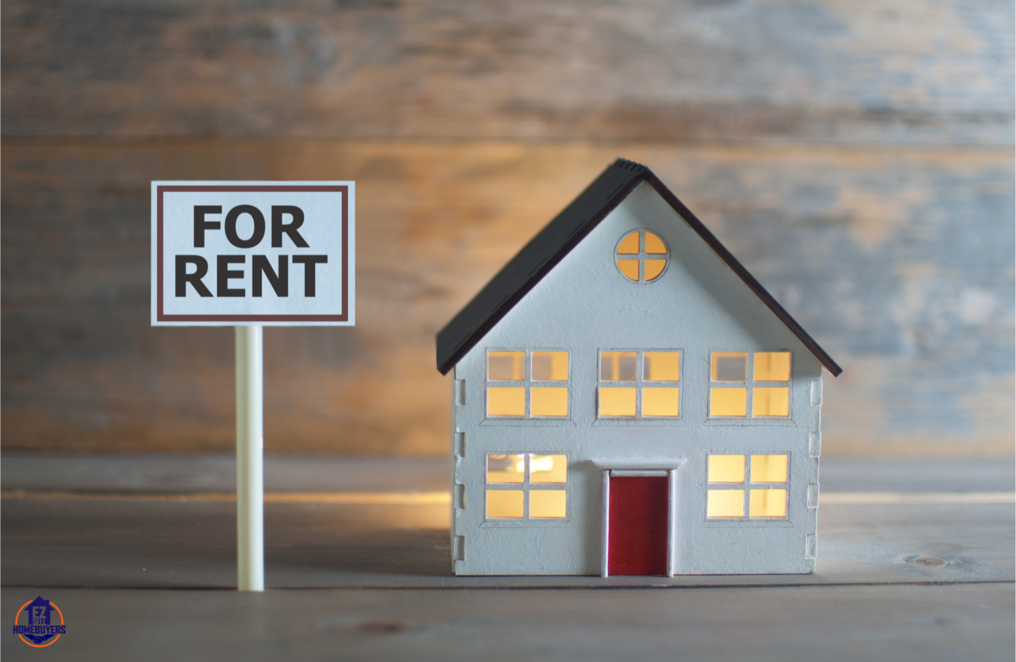 Model home with 'For Rent' sign representing Akron rental property opportunities for wealth-building.