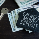 Key and stack of dollar bills with a slate tag reading 'Earnest Money Deposit' symbolizing the initial financial commitment in Ohio home buying process.