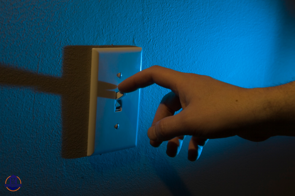 Landlord turning off light switch, illustrating utility shutoff laws in Ohio