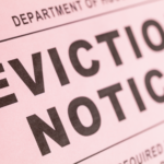 Close-up of an eviction notice highlighting legal steps to remove squatters in Toledo, Ohio