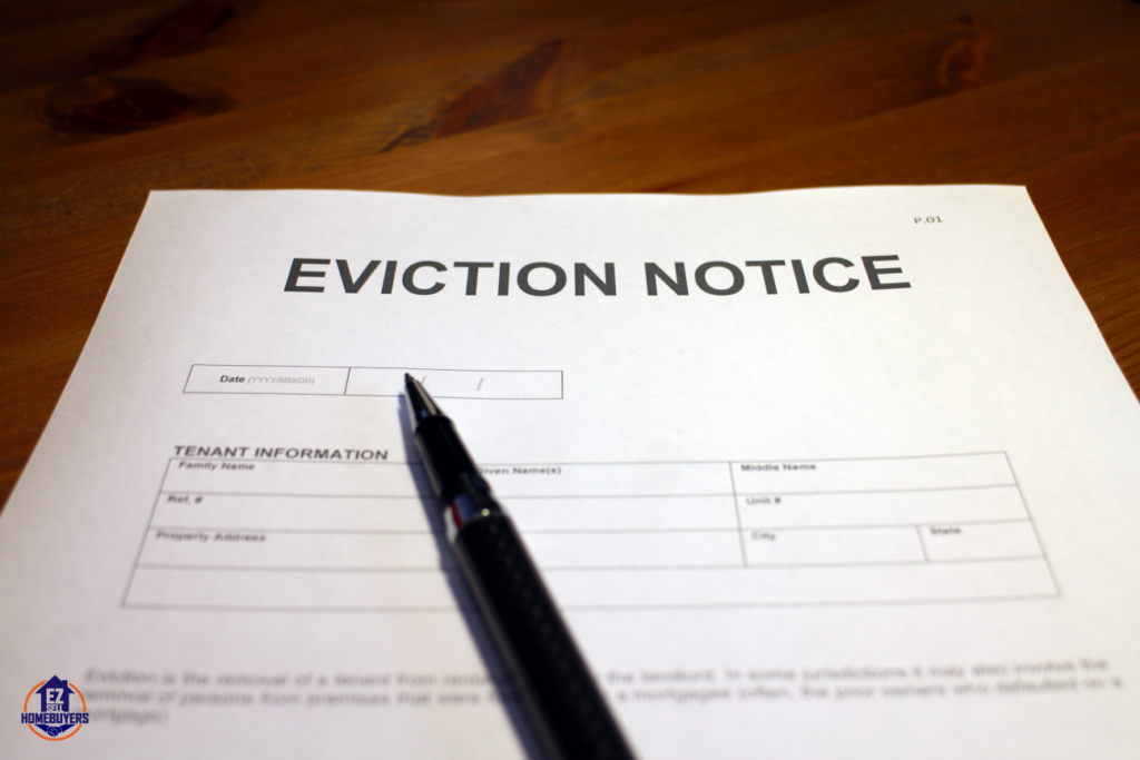 Eviction notice form on wooden table prepared for squatter removal in Cleveland, Ohio.