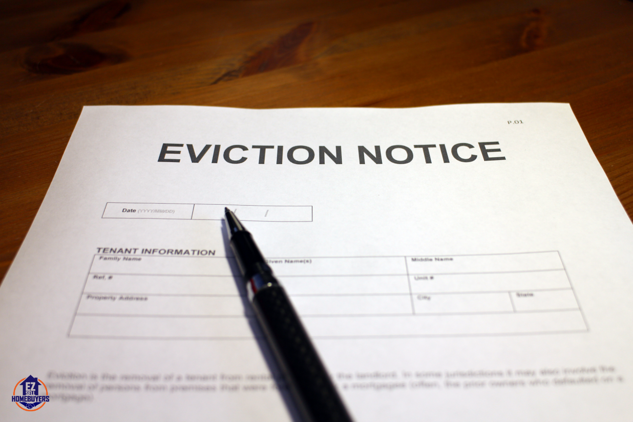 Eviction notice form on wooden table prepared for squatter removal in Cleveland, Ohio.