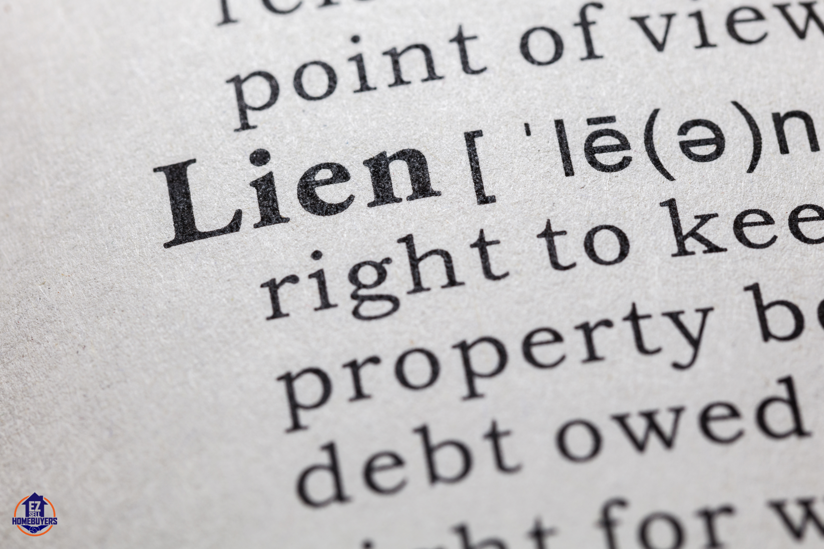 Close-up view of a dictionary definition of 'lien', illustrating the legal right to keep property because of debt, relevant to selling homes with liens in Cleveland.