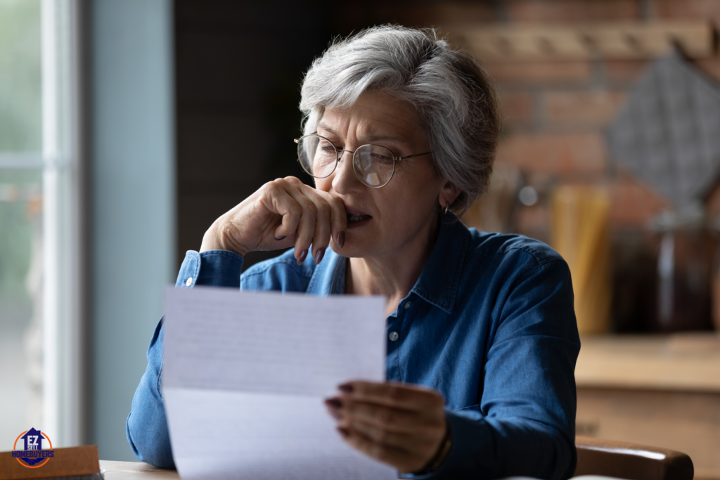 Senior woman reading Medicaid rules for selling home in Ohio, contemplating real estate decisions