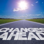 Road sign reading 'Changes Ahead' under a bright sun, symbolizing upcoming shifts in Realtor fees in Ohio following the NAR settlement.