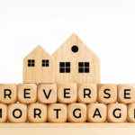 Wooden blocks spelling 'Reverse Mortgage' with small wooden house models, representing reverse mortgage implications in Ohio, probate process, and estate planning.