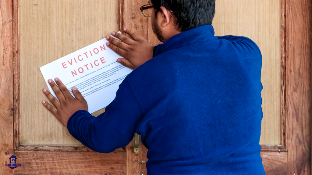 A landlord posting an eviction notice on a wooden door, demonstrating the first step in the eviction process in Ohio without a lease. The notice outlines the legal requirements for tenants to vacate the property, highlighting compliance with Ohio landlord-tenant laws.