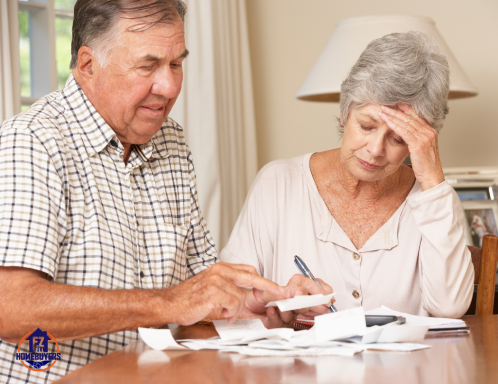 Elderly couple reviewing financial documents with worried expressions, highlighting concerns about protecting their house from nursing home costs and Medicaid estate recovery in Ohio. EZ Sell Homebuyers logo visible in the image.