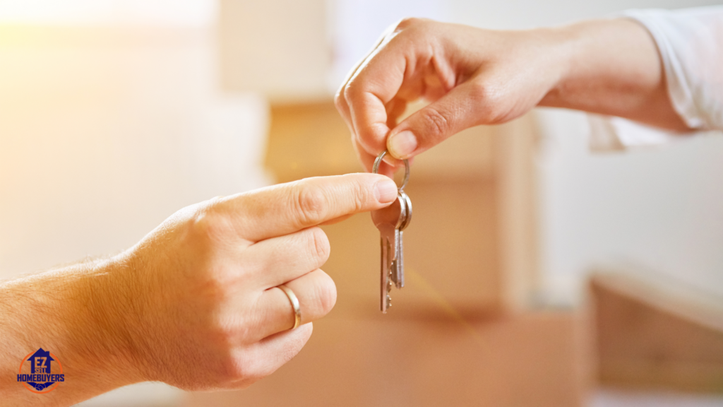 Close-up of hands exchanging house keys, symbolizing inheritance and property transfer, relevant to understanding costs, taxes, and probate when inheriting a house in Ohio.