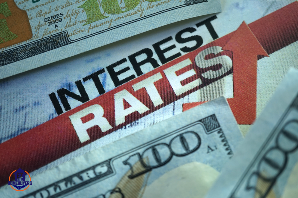 Rising interest rates concept with U.S. hundred-dollar bills and an upward red arrow on a financial newspaper. Mortgage rates in Ohio remain high due to Federal Reserve policies and inflation. EZ Sell Homebuyers logo included.