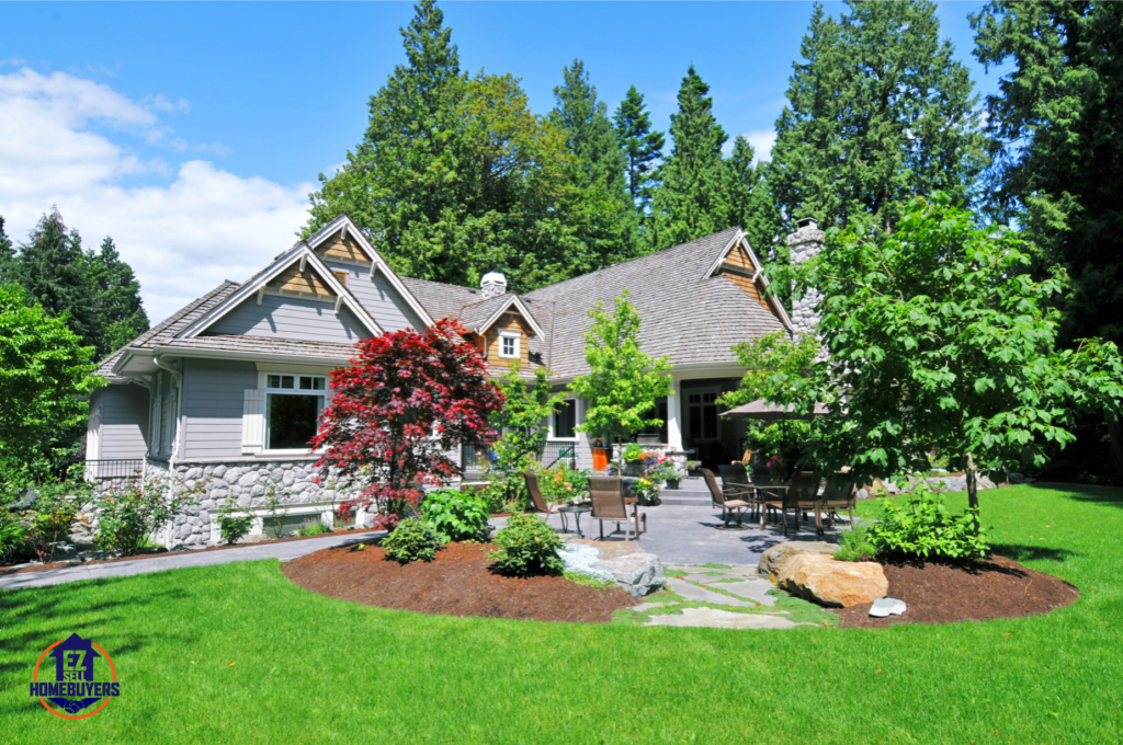 Beautifully landscaped Ohio home with lush green lawn, trimmed bushes, vibrant spring flowers, and an inviting outdoor patio—boosting curb appeal for a fast home sale. EZ Sell Homebuyers logo in the corner.