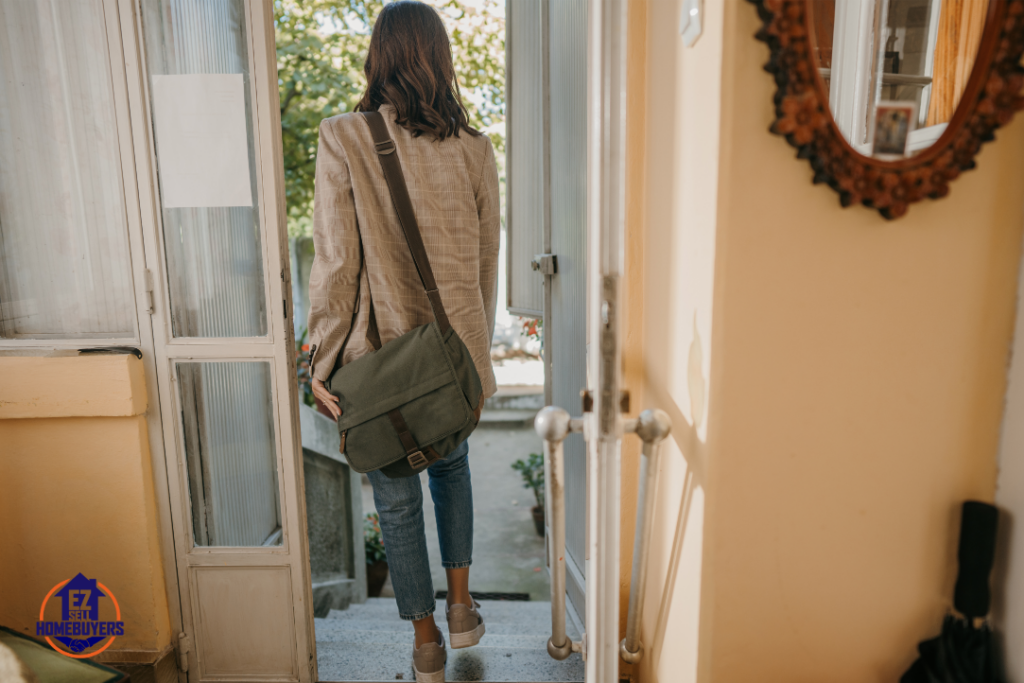 Woman walking away from her Ohio home, symbolizing the emotional and legal consequences of abandoning a house due to mortgage default or foreclosure.