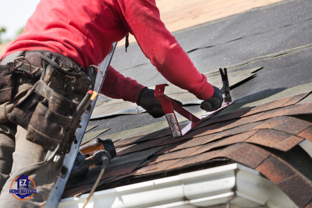 Roofing contractor replacing damaged shingles on an older roof to prevent leaks and structural issues.