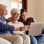 Happy elderly couple with family using laptop to explore estate planning options in Ohio