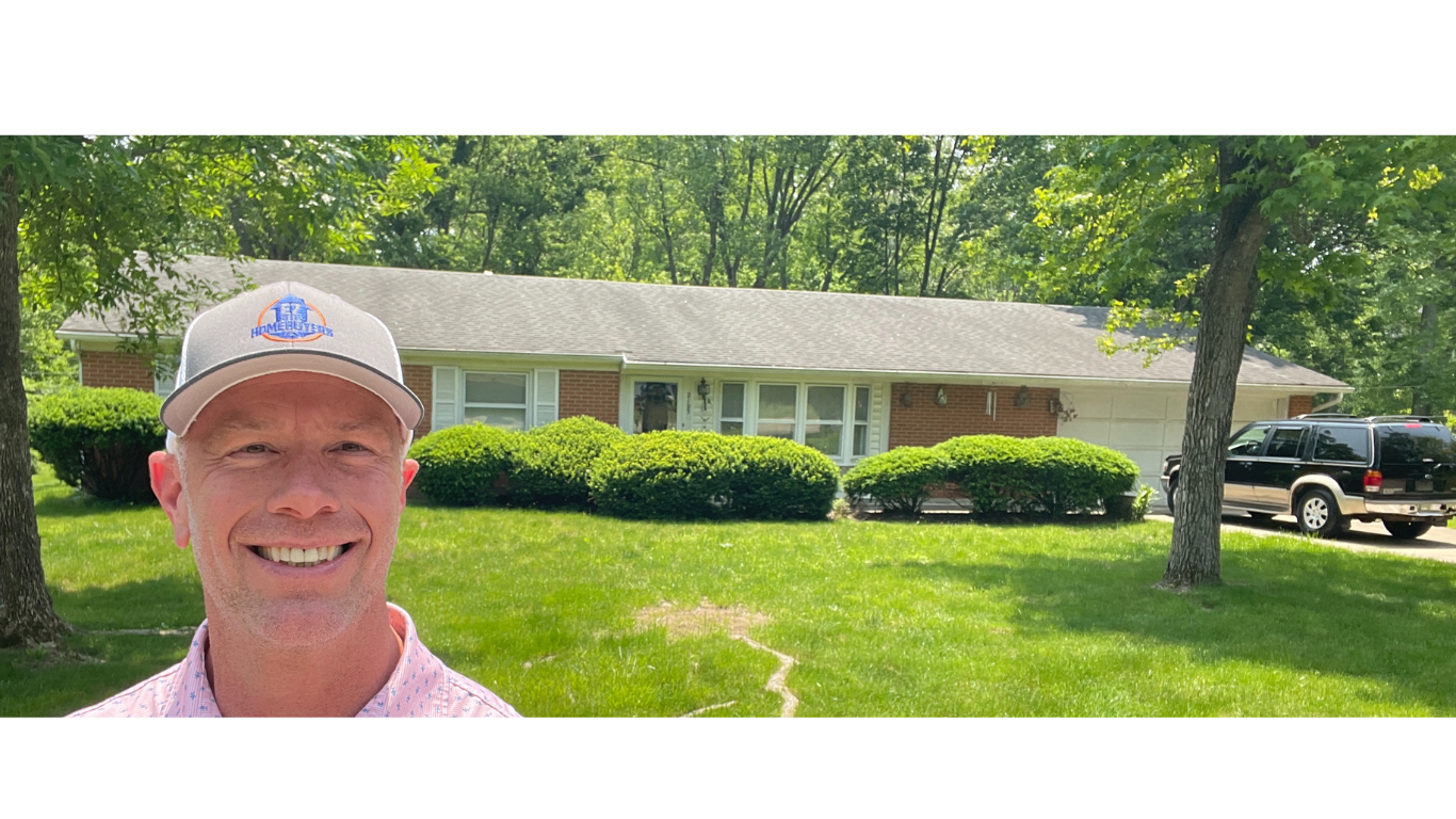 Mike Wall of EZ Sell Homebuyers smiles in front of a single-story brick house in Dayton, Ohio, representing a trusted local company that helps homeowners sell their house fast in Dayton and works with motivated sellers through “we buy houses Dayton Ohio” services.