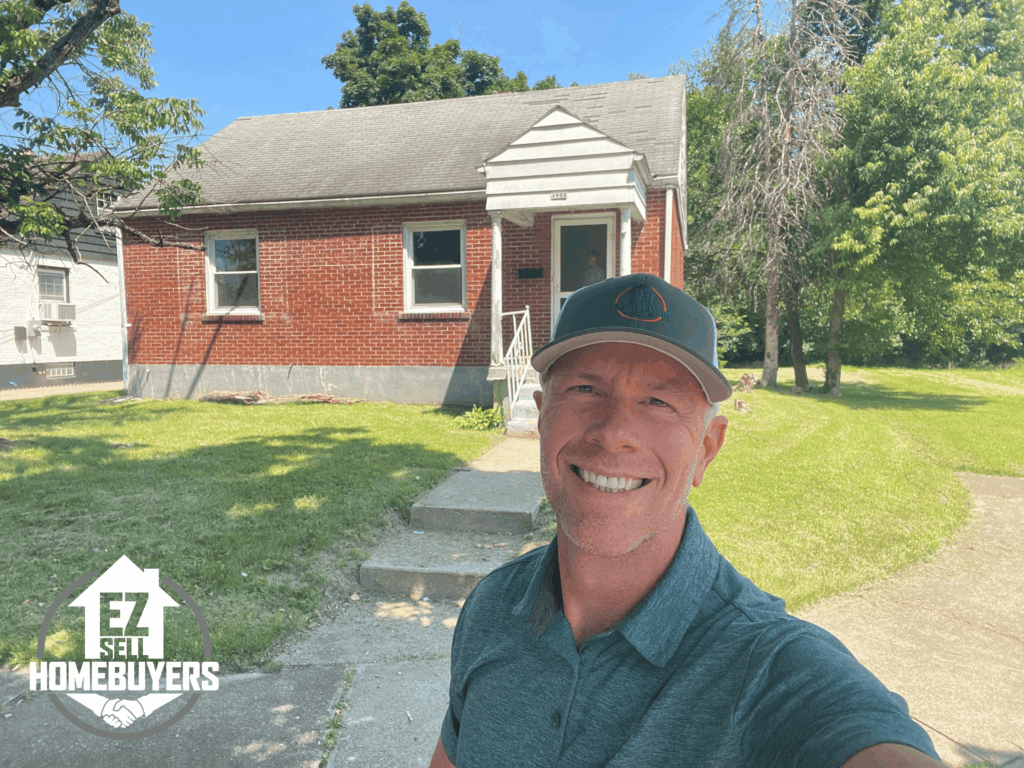 EZ Sell Homebuyers owner Mike Wall standing in front of a Middletown, Ohio single-family home