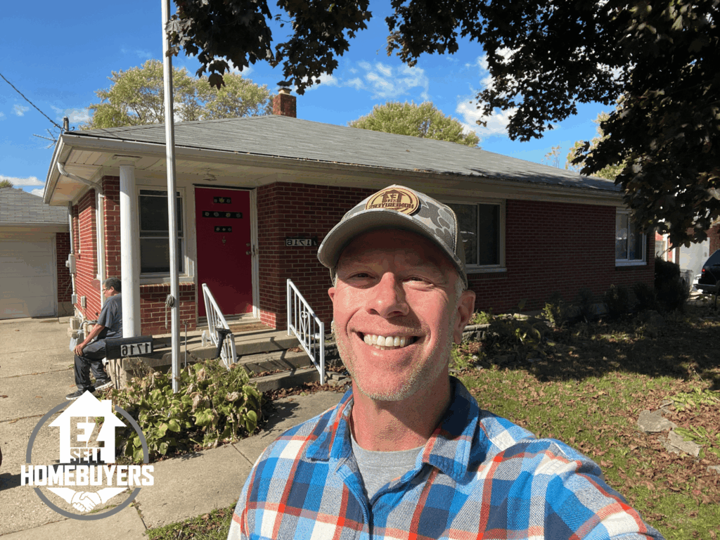 Mike Wall of EZ Sell Homebuyers in front of a Springfield, Ohio brick home