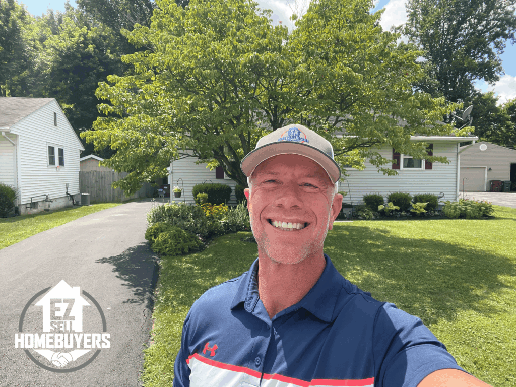 EZ Sell Homebuyers founder Mike Wall in front of a single-story home in Xenia, Ohio