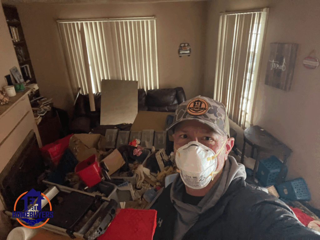 Mike Wall standing at a condemned house in Fairborn, Ohio, after paying off city fines for the seller, Susan.