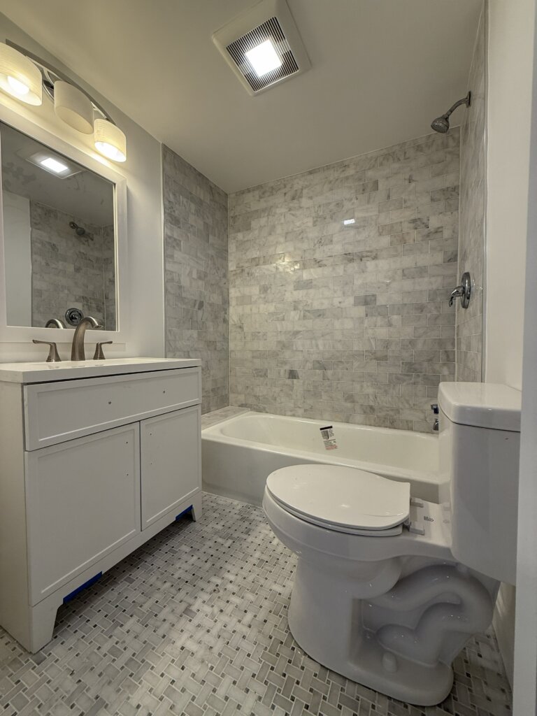 After: Fully renovated primary bathroom with new tile shower and vanity at 43 Buttonwood Road, Halifax MA