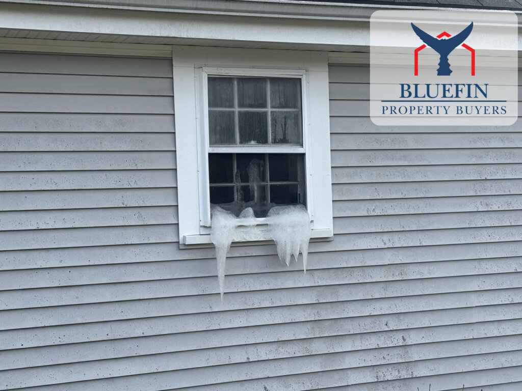 Ice pouring out a window of a vacant Massachusetts house after pipes froze and burst inside
