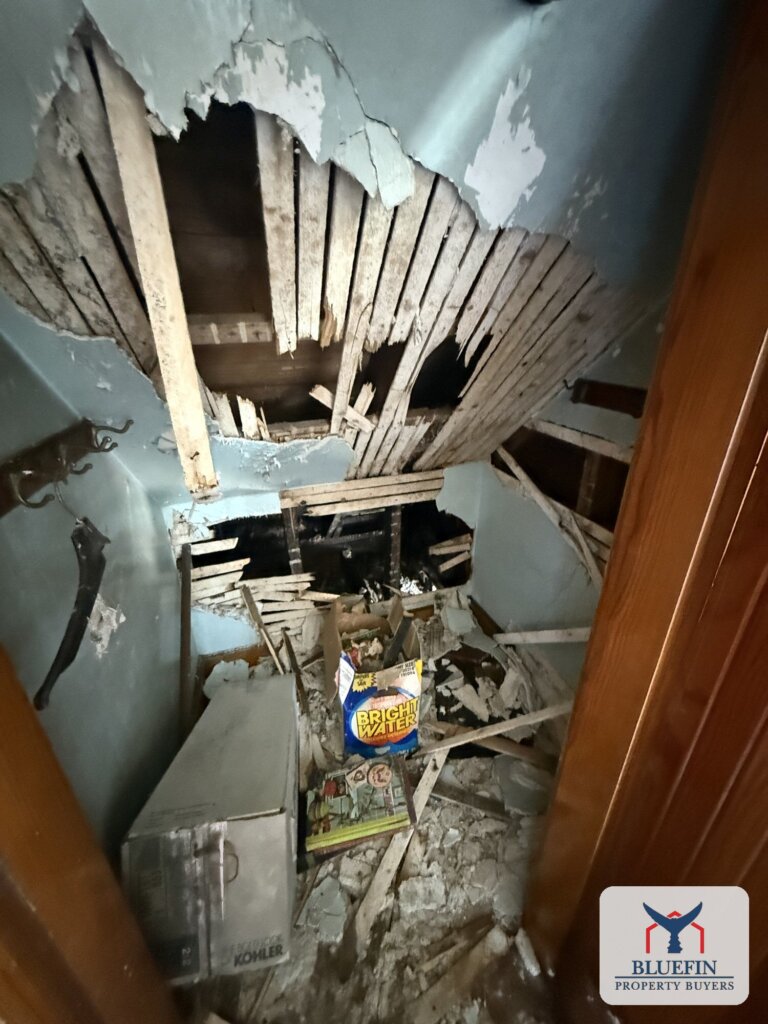 Collapsed ceiling lath and debris inside a closet of a fire-damaged Hull, Massachusetts home