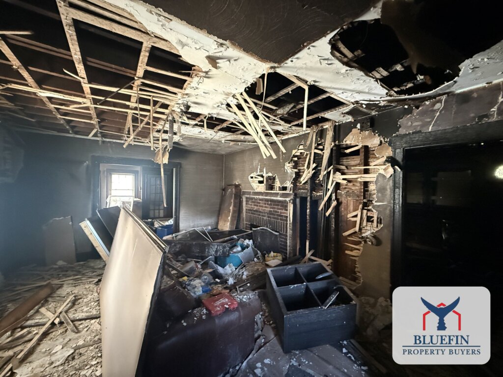 Living room of a Hull, Massachusetts home after a fire, with the plaster ceiling collapsed and lath hanging down