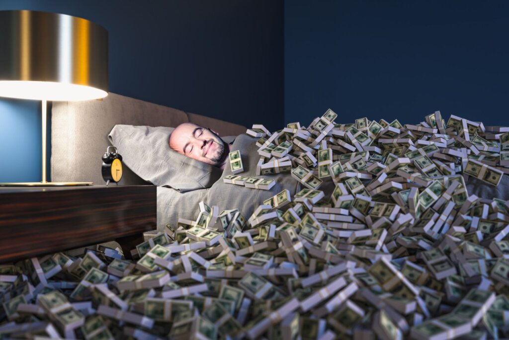 Man sleeping peacefully surrounded by stacks of cash, symbolizing passive income and wealth building through real estate investments.