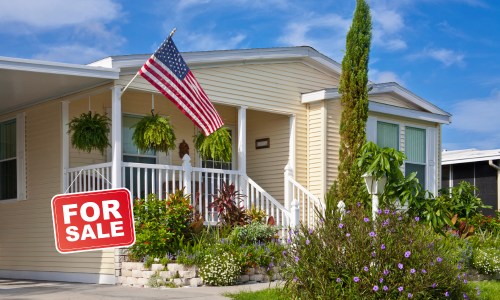 Mobile home with a 'For Sale' sign