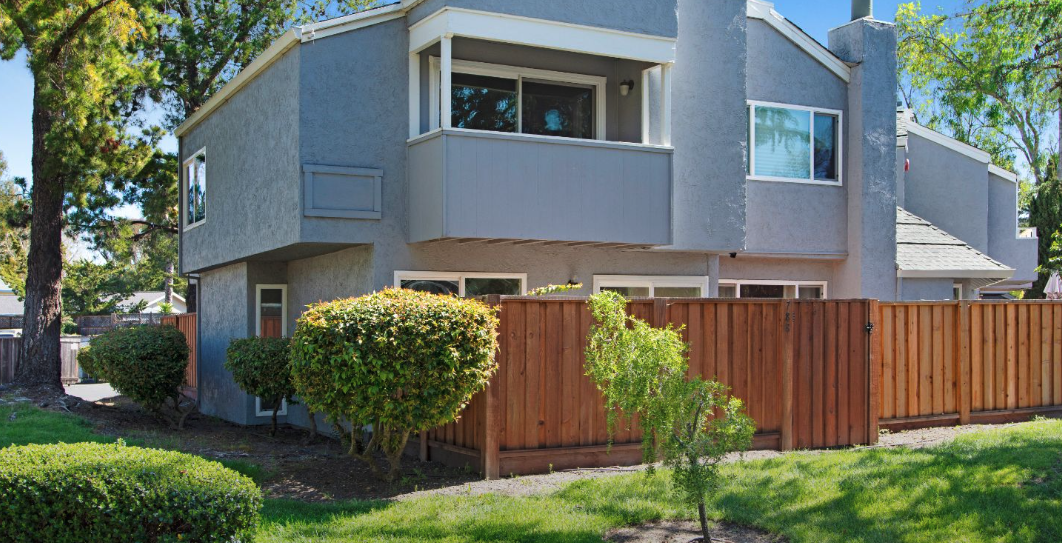 Two-story gray condo with fenced patio at Racquet Club in Rohnert Park, California.