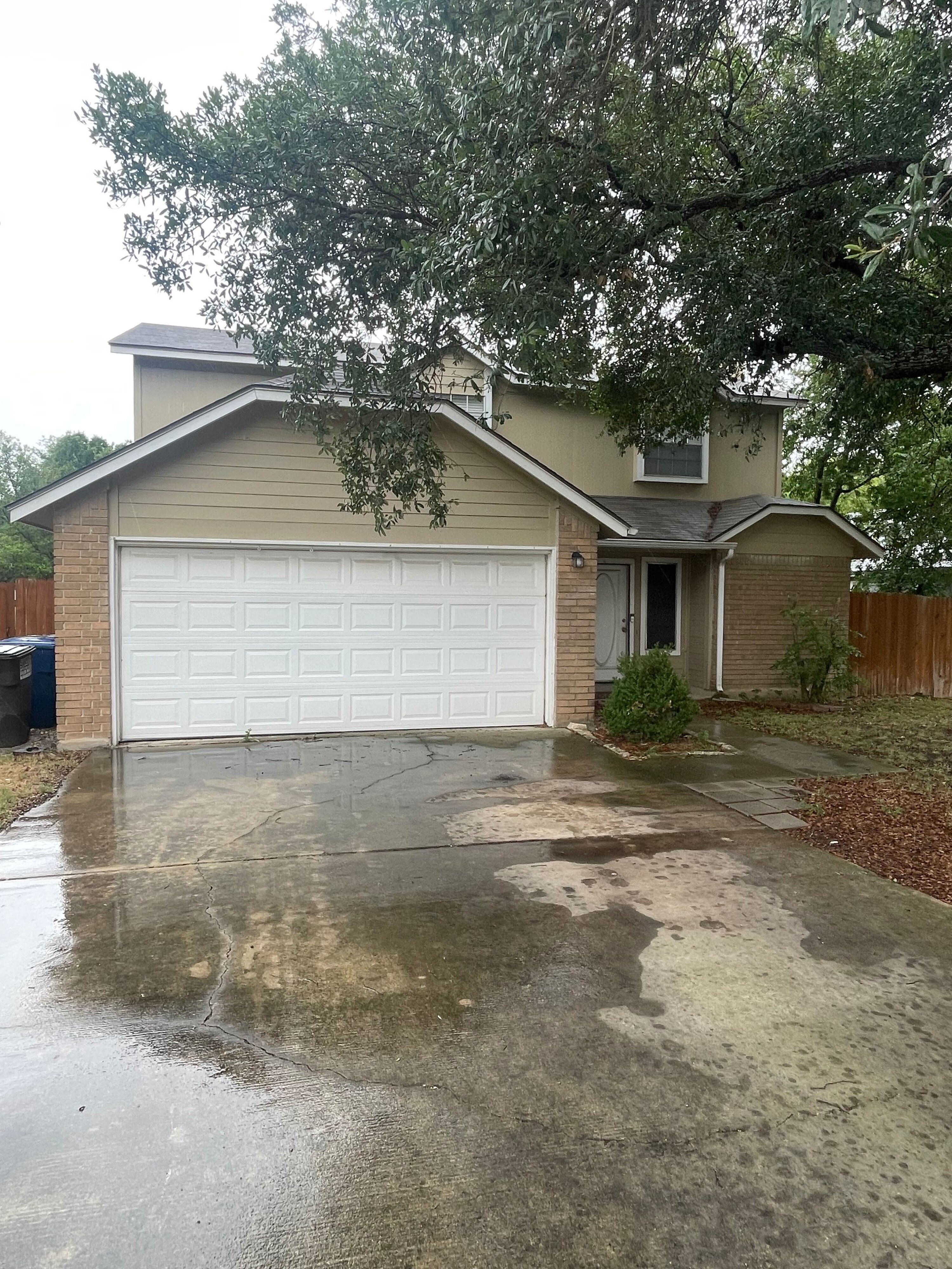 Two-story Texas property with a two-car garage, ideal for home buyers and cash buyers in the real estate market.