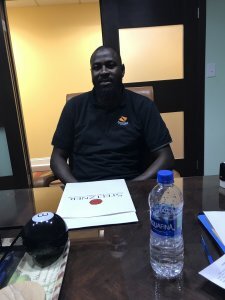 Mouhamadou T. at the closing table after Zack Buys Houses bought his house
