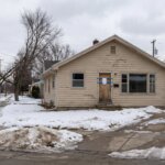 Winnipeg home exterior in winter with government notice on door