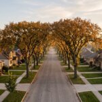 A tree-lined Winnipeg street of post-war bungalows with elm leaves turning gold, illustrating the fall 2026 Winnipeg housing market for home sellers