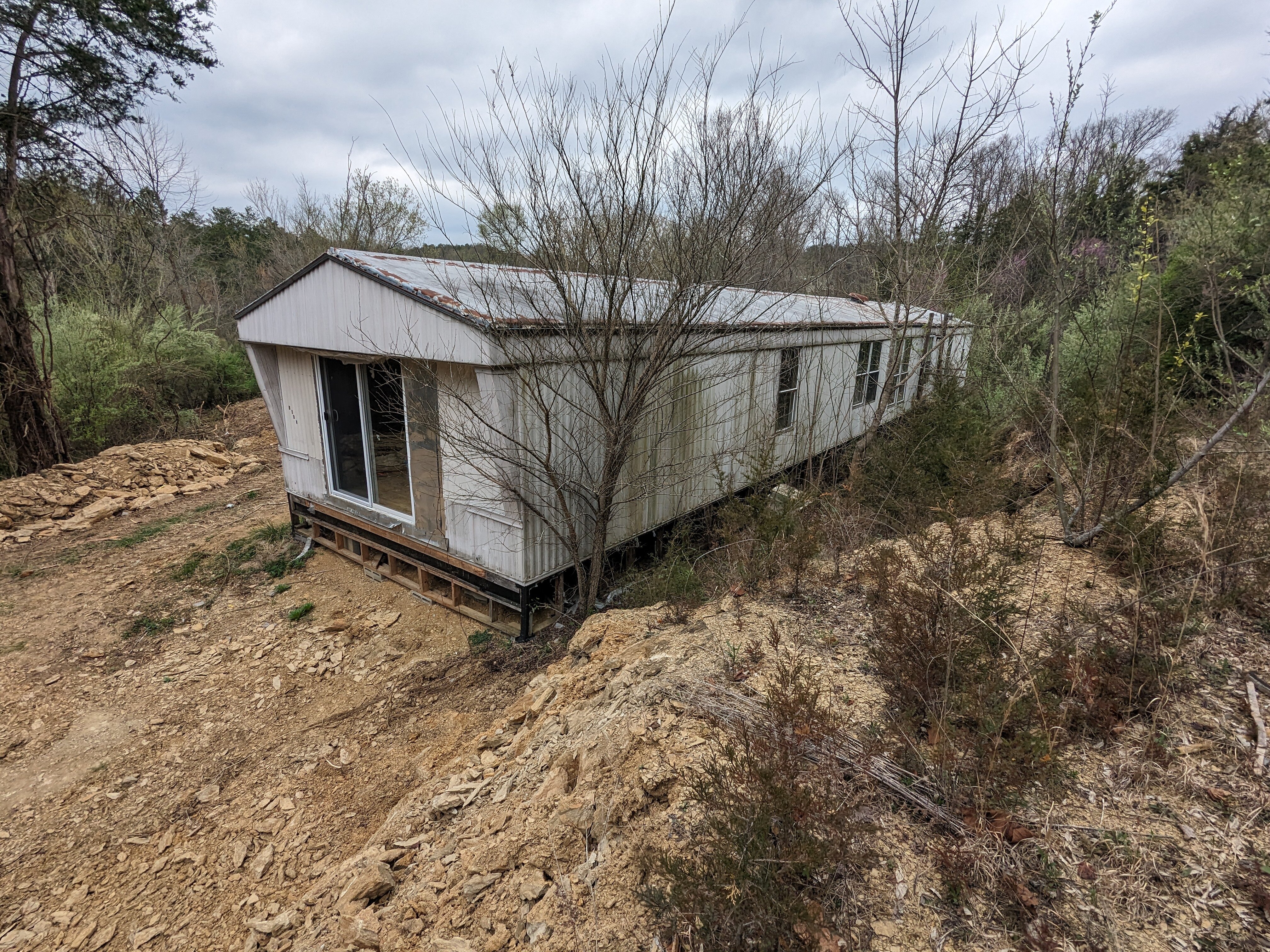 Real estate investor inspecting mobile home on Knox County land