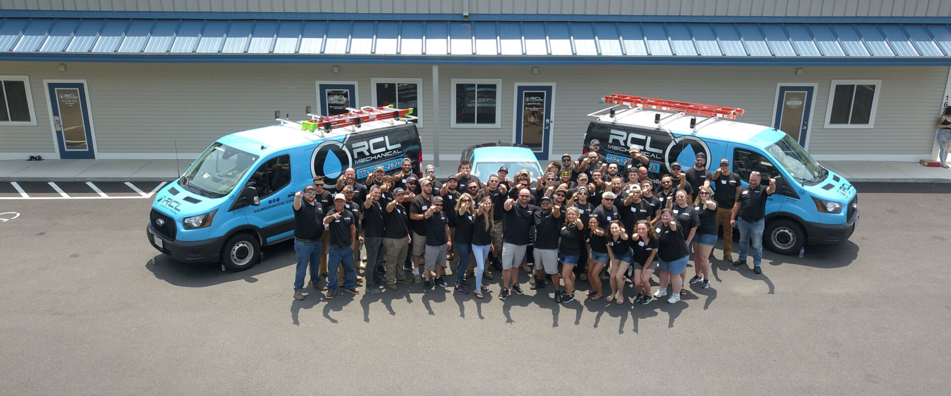 RCL Team in front of office with trucks