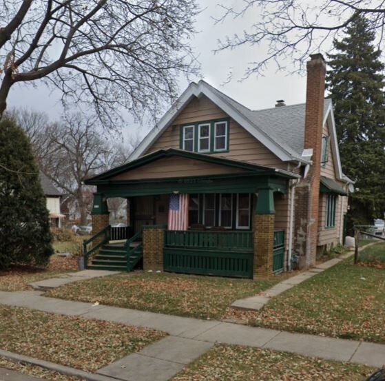 a old style home with an neat lawn in autumn